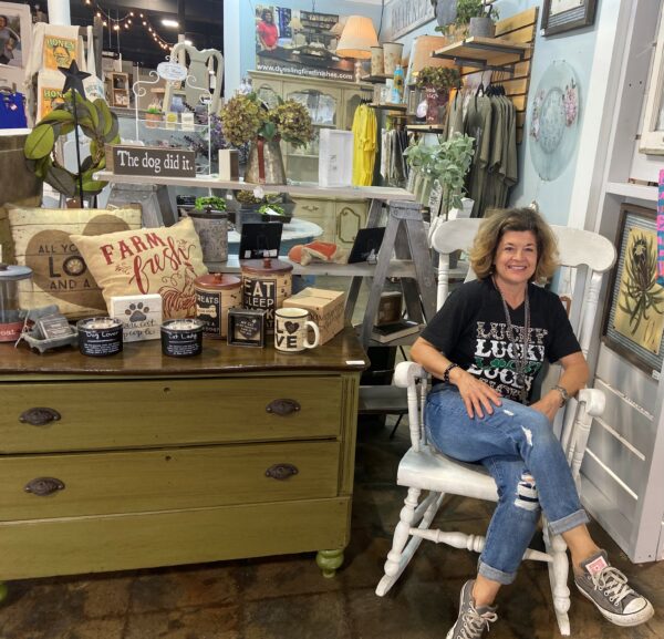 Susanna, who was determined to hear, posing for a photo in front of her furniture storefront. 