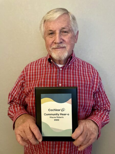 Wayne, the 2022 Hear-o of Year winner holding his plaque. 