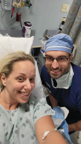 Stephanie posing for a selfie with her surgeon pre-op for her Osia System for single-sided deafness