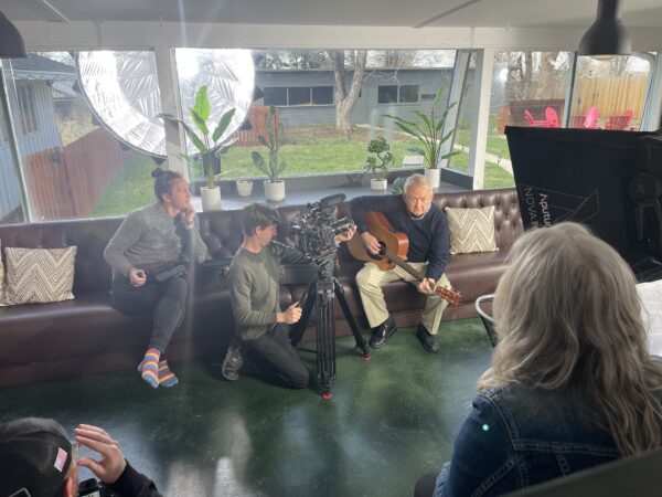 Cochlear implant recipient Mike, plays his guitar in a behind the scene's video shoot. 