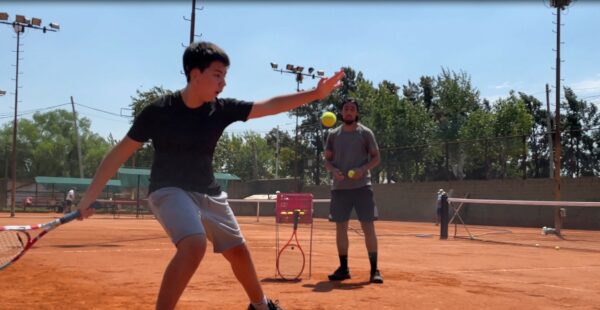 Ignacio practicing tennis with coach; recipient connects with Baha 6 Max