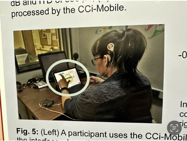 Rhona who experienced a hearing win with her cochlear implants, participating in a sound quality test with one of her first cochlear implant devices. 