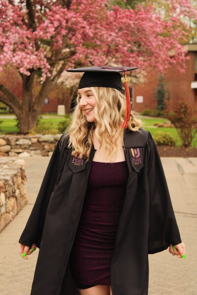 Samantha, who regained her confidence from severe hearing loss from Cystic fibrosis with her cochlear implants, posed for a photo in her graduation gown. 