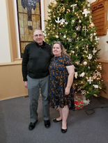 Dennis standing near a holiday tree ready to share his tips for hearing during the holidays.