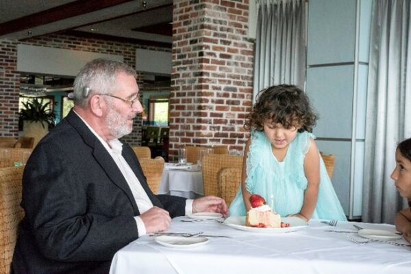 Recipient with children at a restaurant; hearing practice exercises