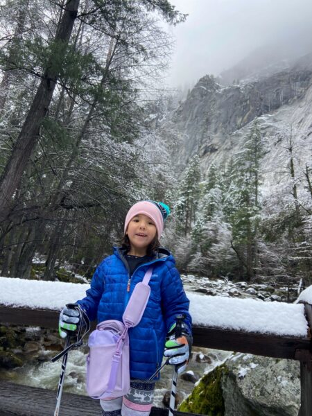 Adrian, an Osia System recipient, shown in a mountain setting with snow falling, smiling for a picture. 