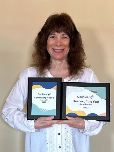 Jane, the 2023 volunteer Hear-o of the year showing off her plaques. 