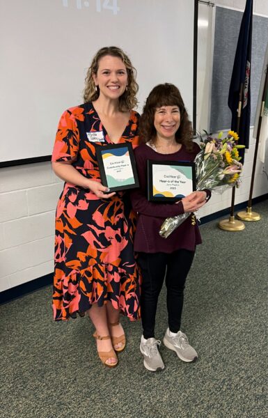 Jane, the 2023 volunteer Hear-o of the year, with Martha Schley Smith. Jane is holding her plaques and flowers.
