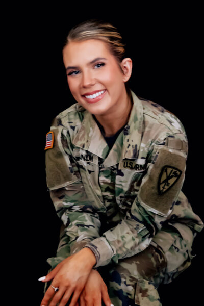 Vanessa, an Army veteran who uses the Osia System, smiling and posing in her Army uniform.