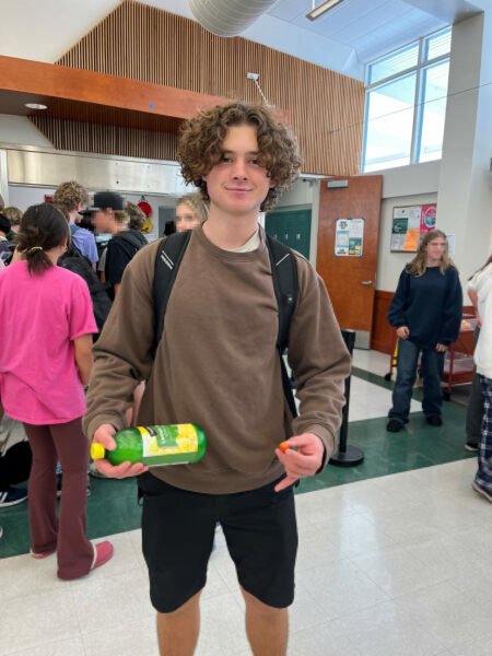 Michael, who is an advocate and member of the Cochlear Mentor program, posing for a picture and smiling in his high school cafeteria. 