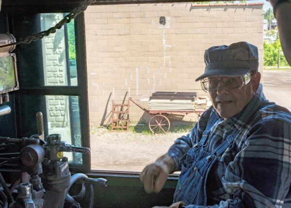 Fred, a bilateral Nucleus 8 Sound Processor recipient, sitting in conductor's seat in a train.