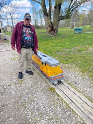 Fred, a bilateral Nucleus 8 Sound Processor recipient, smiling with a toy train.