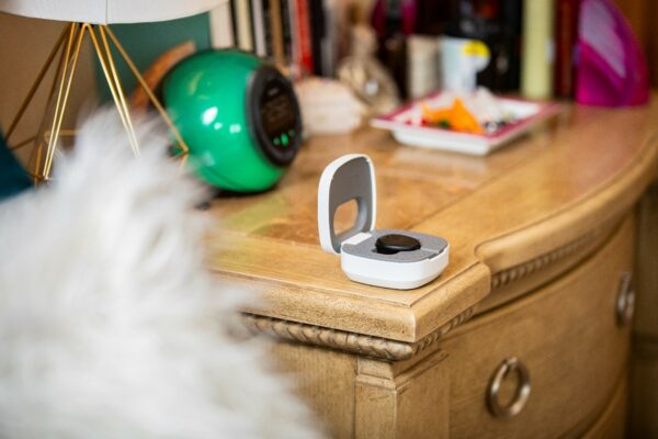 Bedside table with a Cochlear Home Charger; hearing with a Nucleus Kanso 3 Nexa Sound Processor.