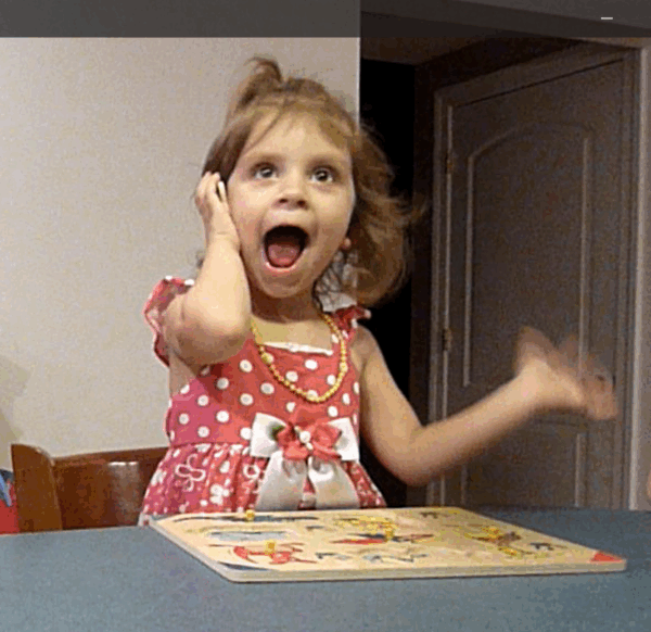 Brynn, a Cochlear™ recipient pictured as a small child using her device and hearing sound.