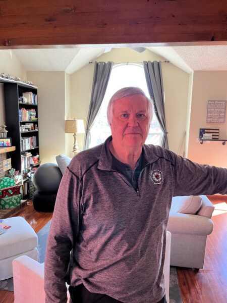 Dwight stands in his living room, proud of his journey from a Baha System to an Osia System.