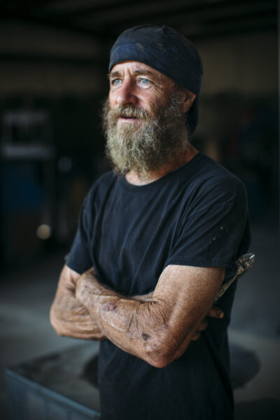 Kelly, a cochlear implant recipient who plays guitar, is in his workshop where he welds. 