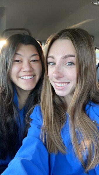Addy, a girl with single-sided deafness who uses the Osia System, smiling for a selfie with a fellow nursing student.