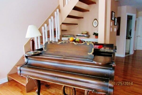 Julie's piano in the middle of her living room; cochlear implant bimodal hearing solutions and music