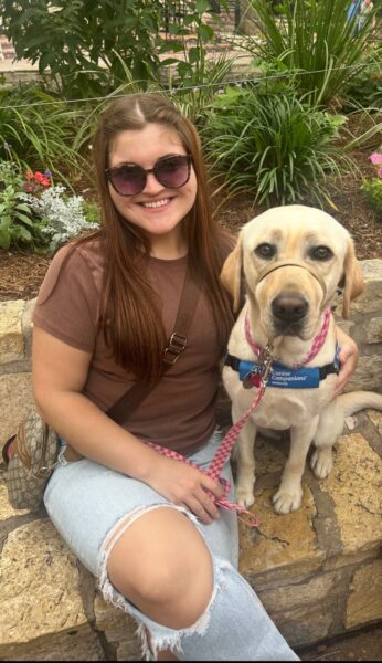 Skylynn sits with her hearing dog, and shares how she gained confidence with her cochlear implant.