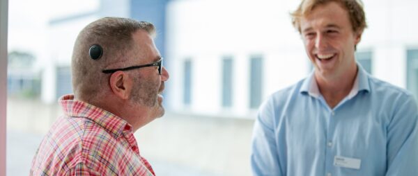 Recipient wearing a Kanso 3 Sound Processor talking, and smiling with another person