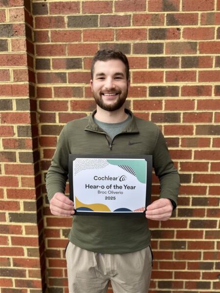 Broc, the 2025 Hear-o of the Year stands proudly with his Hear-o plaque. 