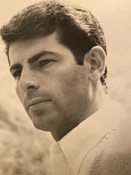 A side profile photo of Gene, whose cochlear implant helped his career, in a sepia toned headshot from the 1970s.