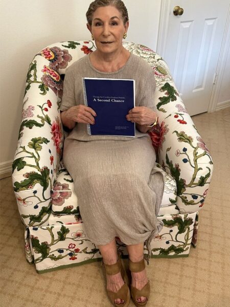Carole showing her hearing rehabilitation manual: Therapy for Cochlear Implant Patients: A Second Chance.