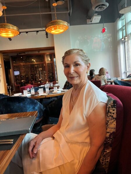 Carole smiling in a restaurant