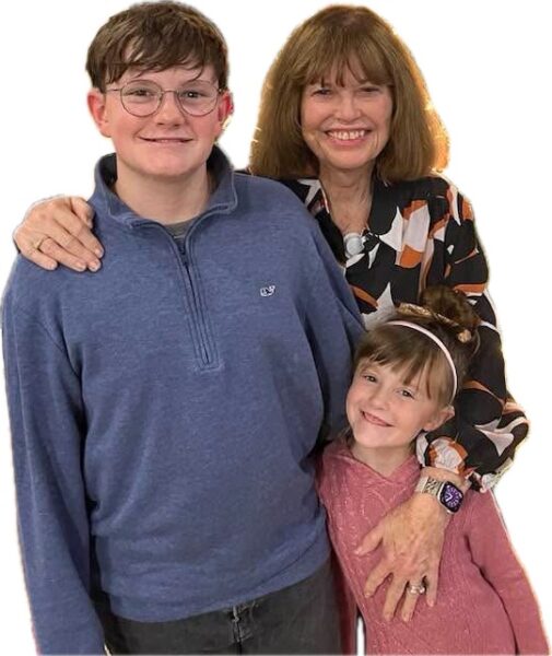 A family photo of Leigh, Camden and Fiona, standing close with their arms around each other - Camden and Fiona’s cochlear implant journey's helped inspire children's books.